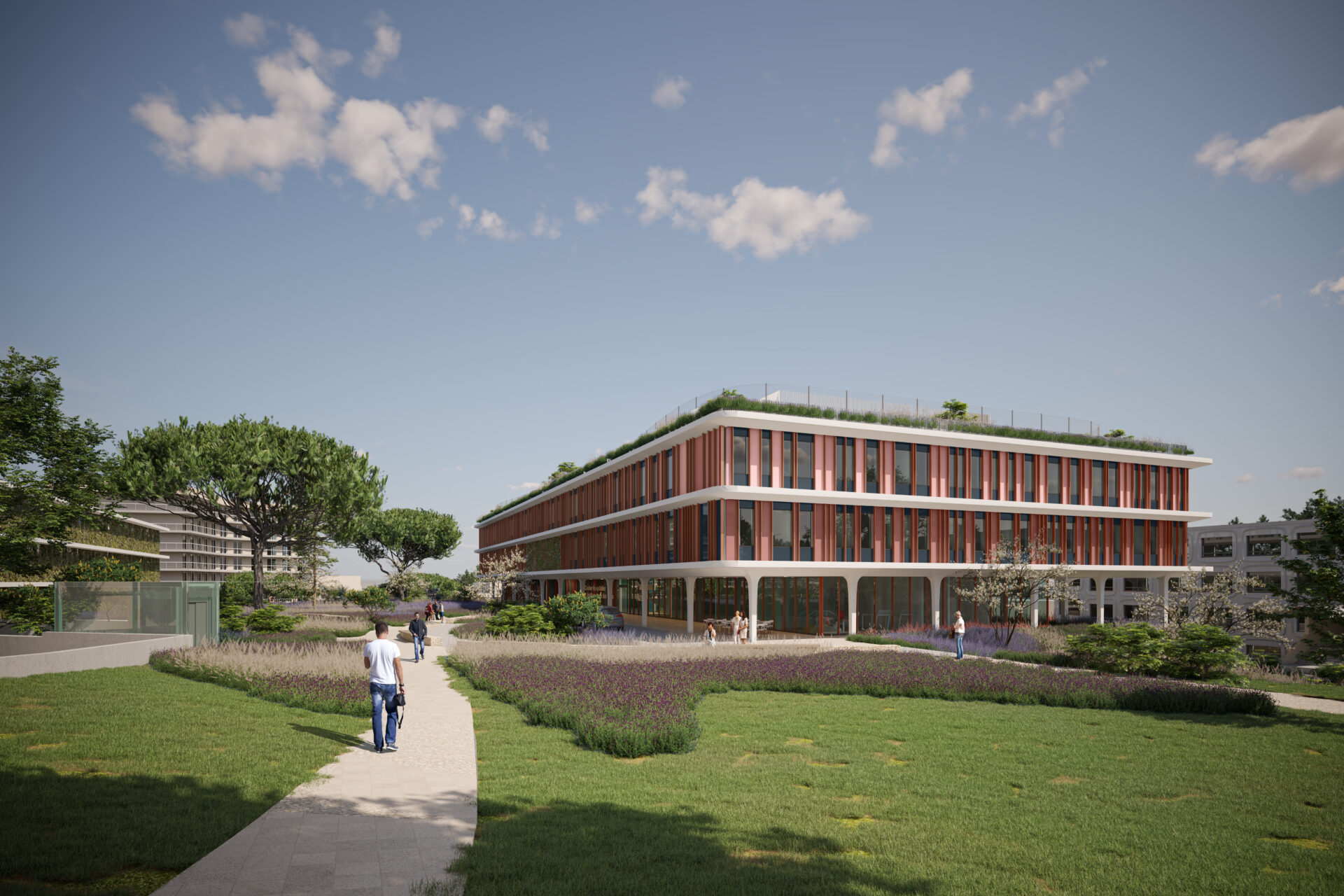 Centre Hospitalier à Antibes vu depuis un parc environnant, mettant en avant l'intégration du bâtiment de santé dans le paysage urbain, conçu par A26 avec un focus sur l'accessibilité et la sécurité hospitalière.